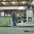 Patrizio Tapparelli all'interno del laboratorio di produzione, alle prese con l'assemblaggio di due stufe in maiolica.